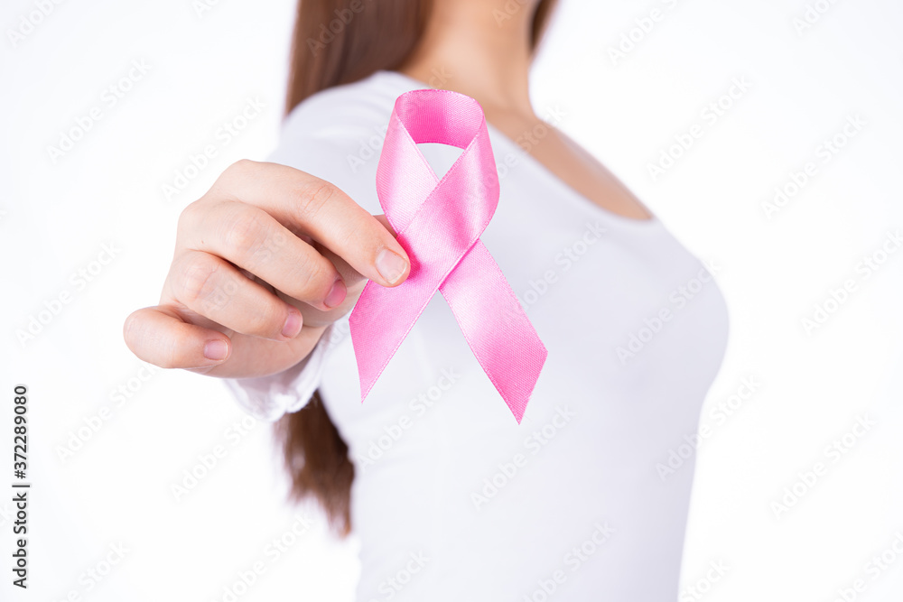 Breast cancer awareness ribbon on woman chest isolated over white background. Medical, healthcare for advertising concept. Breast cancer awareness ribbon on woman chest isolated over white background. Medical, healthcare for advertising concept.