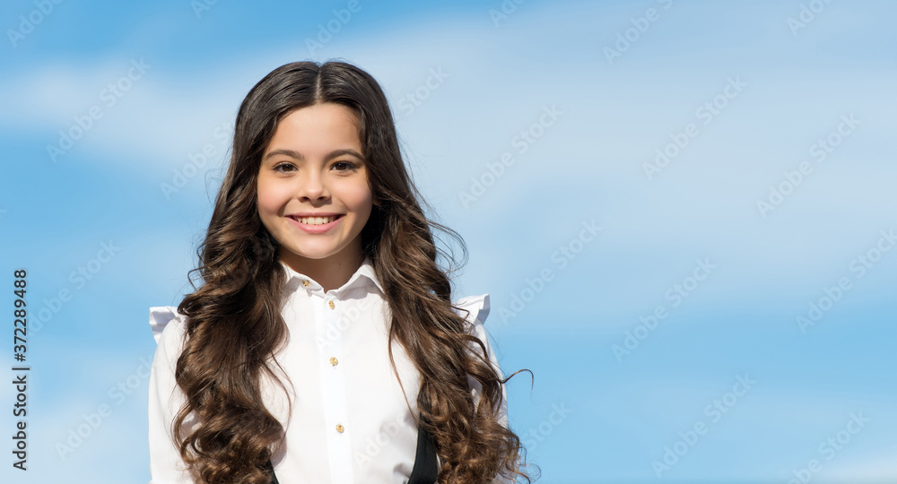 Impress them by your look. Beauty look of happy child. Little girl wear long wavy hairstyle sunny sky. Hair salon. Haircare cosmetics. Hairstyling products. Refine yourself, ocpy space Impress them by your look. Beauty look of happy child. Little girl wear long wavy hairstyle sunny sky. Hair salon. Haircare cosmetics. Hairstyling products. Refine yourself, ocpy space