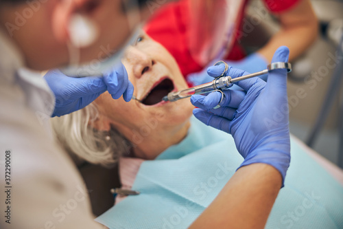 Woman giving dentists examined the teeth are anesthesia