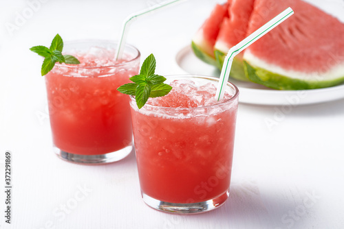 Summer cold drink with watermelon and mint on a wooden background. Copy space
