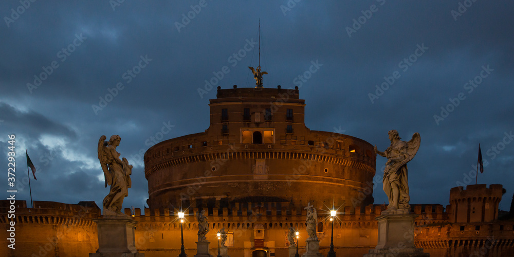 Naklejka premium The beautiful Castel Sant'Angelo. Exterior view of the Castel Sant'Angelo and of the Bridge of Angels across the river Tiber at the night, Rome, Italy