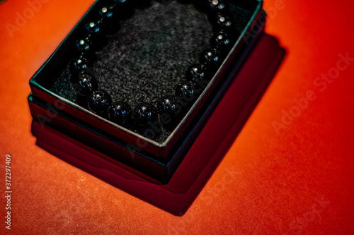 Black beads with red background