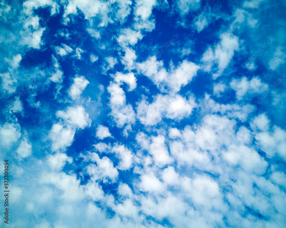 Wide blue summer sky with white cirrus,cumulus and layered air clouds on beautiful bright sunny day. Bright banner,texture or abstract background for text, blog, design,agency, website, pattern, model Wide blue summer sky with white cirrus,cumulus and layered air clouds on beautiful bright sunny day. Bright banner,texture or abstract background for text, blog, design,agency, website, pattern, model