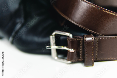 Black shoes and elegant brown belt, close up view, fashion lifestyle 