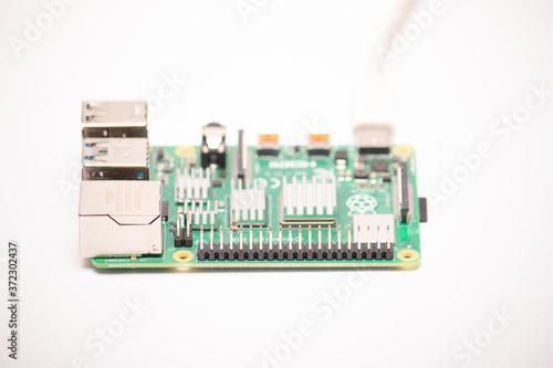 Kiev, Ukraine - August 13th, 2020: Close-up of a powered Raspberry Pi 4 Model-B on a white background. The RPI4 is a credit-card-sized single-board microcomputer developed in the UK © PeterPike