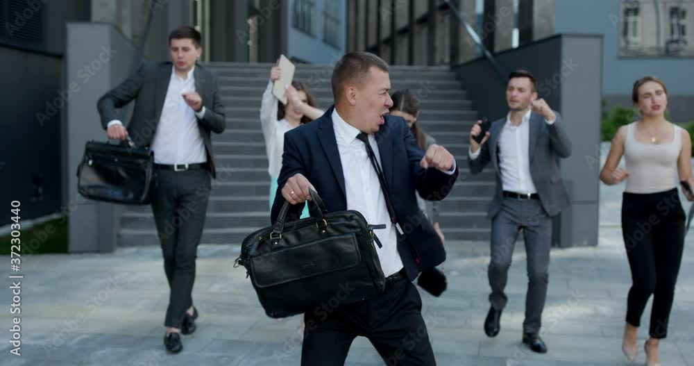 Overjoyed excited male leader and carefree business team dance together, happy staff group enjoy fun celebrate success victory concept Overjoyed excited male leader and carefree business team dance together, happy staff group enjoy fun celebrate success victory concept