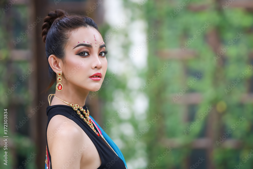 Portrait of beautiful asian Thai girl. Young hindu woman model with kundan jewelry set. Traditional India costume blue saree and lehenga dress in garden. Portrait of beautiful asian Thai girl. Young hindu woman model with kundan jewelry set. Traditional India costume blue saree and lehenga dress in garden.