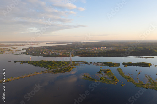 Spring flooding on the river  flooded forest  islands on the river. View from a drone  a bird s-eye view. View without the presence of people in the evening. 