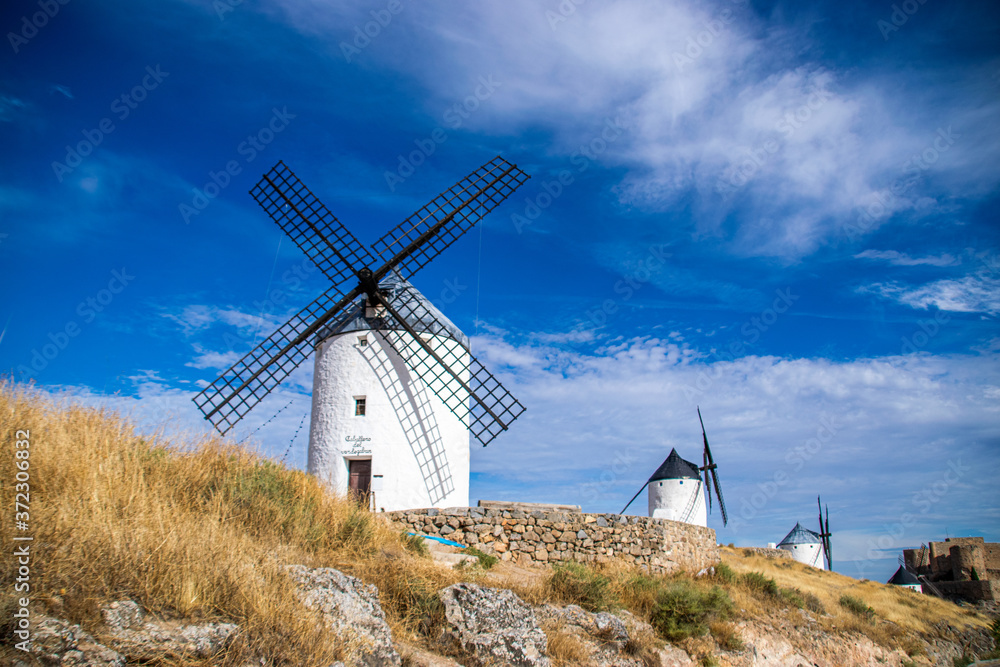 Photo of some beautiful and historic windmills located in Consuegra, Toledo, Spain during a sunny day of summer in a natural place. 
