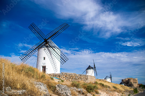 Photo of some beautiful and historic windmills located in Consuegra, Toledo, Spain during a sunny day of summer in a natural place. 