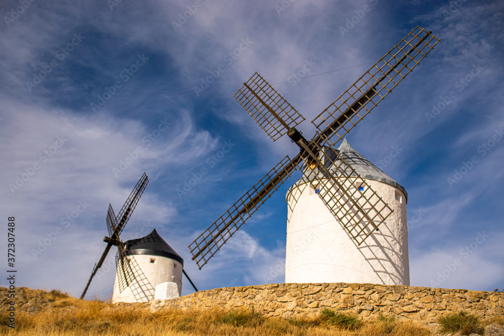 Photo of some beautiful and historic windmills located in Consuegra, Toledo, Spain during a sunny day of summer in a natural place. Photo of some beautiful and historic windmills located in Consuegra, Toledo, Spain during a sunny day of summer in a natural place.