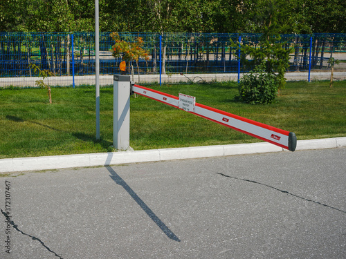 Noyabrsk, Russia - August 9, 2020: red-white parking barrier, automatic entry system