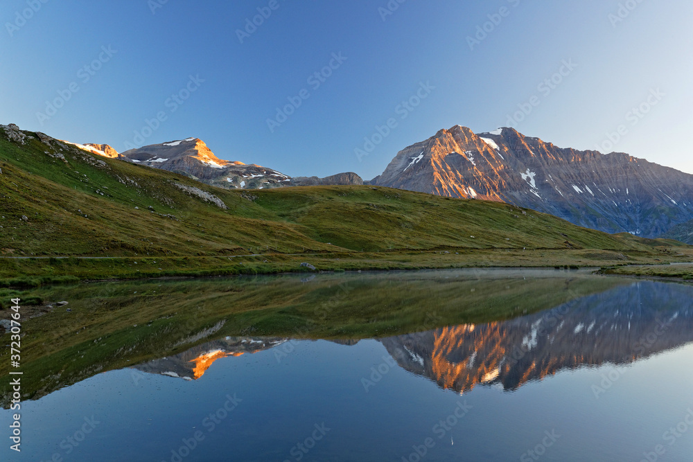 Refelctions on a mountain lake at sunrise
