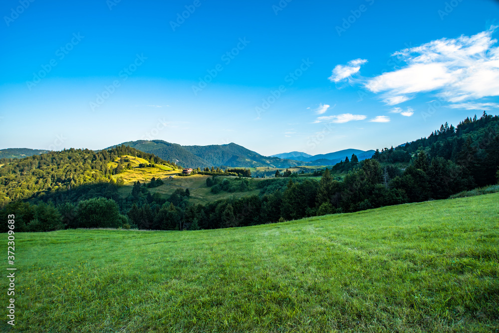 mountain valley on a background of mountain peaks and forests. blue sky. morning in nature.