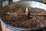 Coffee beans is roasting in roaster machine in coffee shop.