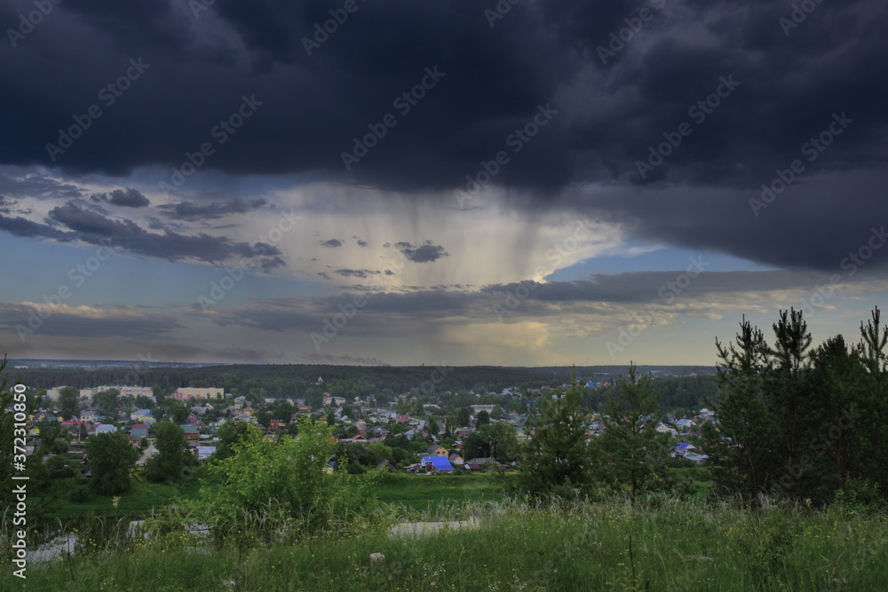 Summer rain over the city in a dry summer. Cloudy day in the Western Urals.
