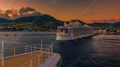 A cruise ship leaves Basseterre Bay at sunset in St Kitts photo