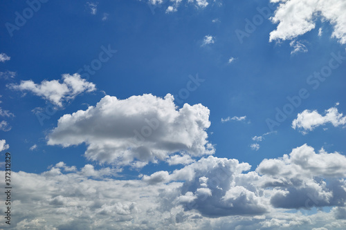 Shiny cumulus clouds in beautiful blue sky