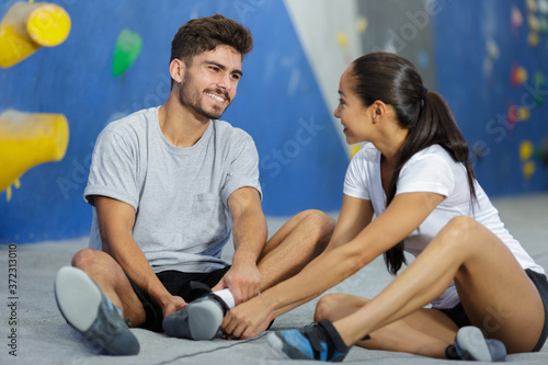 delighted couple sitting in a climbing gym