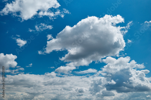Azure sky is covered with cumulus clouds