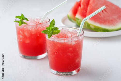  Summer cold drink with watermelon and mint on a wooden background. Copy space