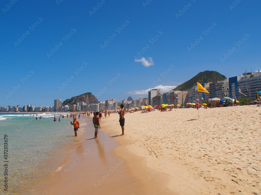 Rio de Janeiro, Brazil - 03/09/2020: sunny day on the coast of the Atlantic ocean, Copacabana beach. Copy space for text.