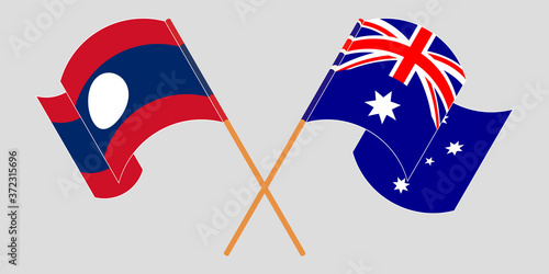 Crossed and waving flags of Laos and Australia