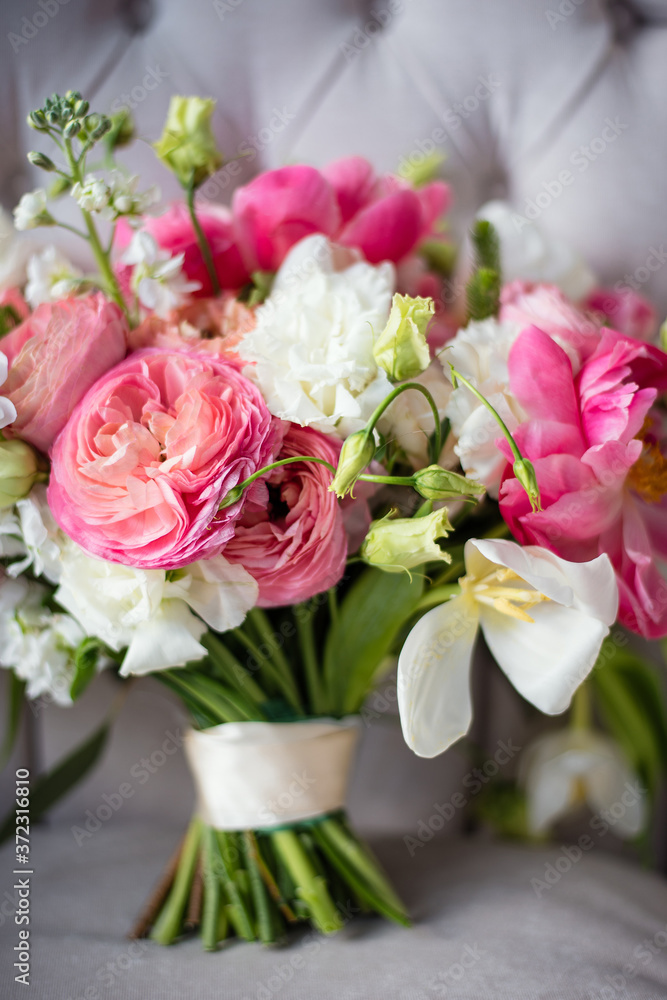 delicate bridal bouquet of pink and white flowers, flower close-up, selective focus, bouquet is on light gray armchair delicate bridal bouquet of pink and white flowers, flower close-up, selective focus, bouquet is on light gray armchair