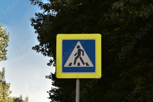 Road sign "Pedestrian crossing" in the city street