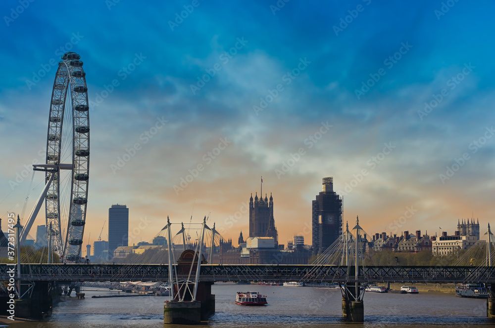 A view along the Thames in London, UK at dusk.