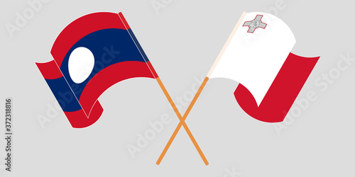 Crossed and waving flags of Laos and Malta