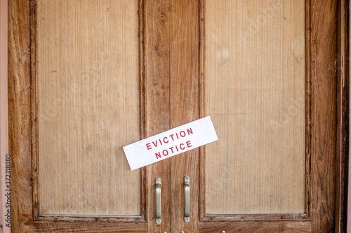 Eviction notice pasted on the entrance door of the house.