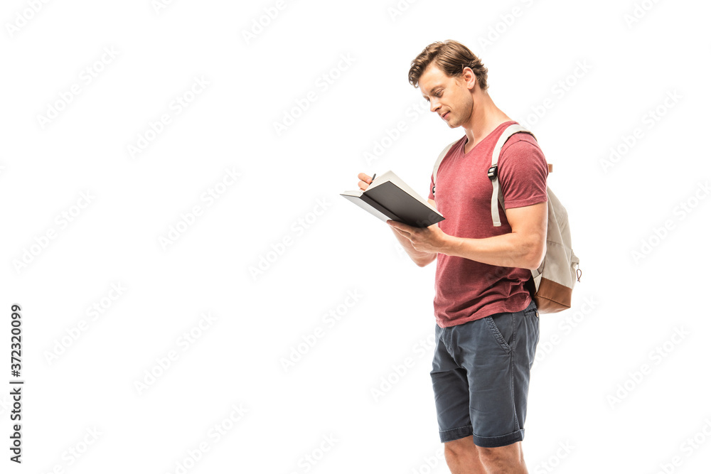 Student with backpack writing on notebook isolated on white Student with backpack writing on notebook isolated on white