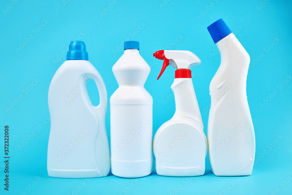 group of blank detergent product bottles over blue background. copy space. cleaning and washing equipment concept group of blank detergent product bottles over blue background. copy space. cleaning and washing equipment concept