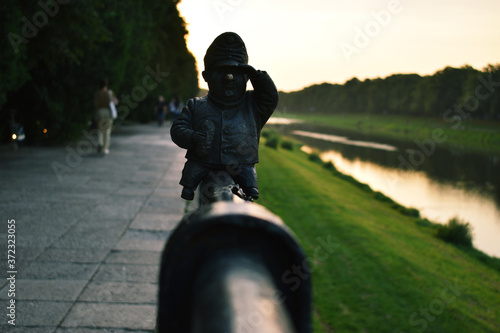 statue near the river photo