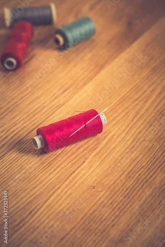 spools of thread on a wooden background. DIY concept.