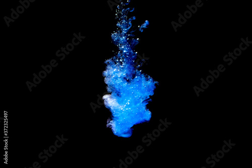 A cloud of blue paint released into clear water. Isolate on a black background.