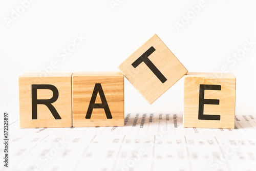 Word rate. Wooden small cubes with letters isolated on white background with copy space available.Business Concept image.