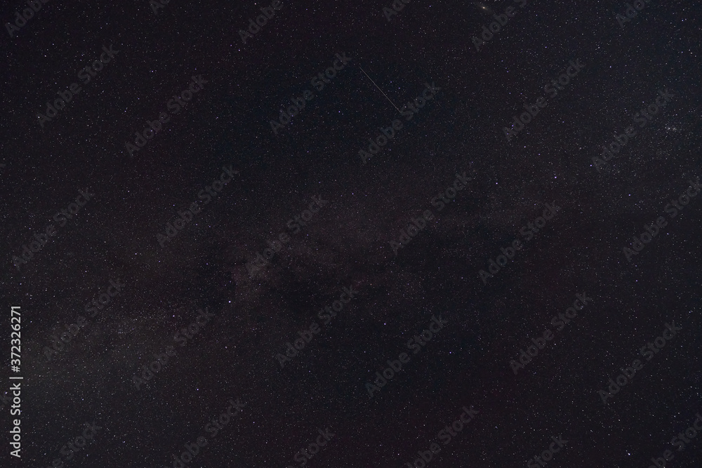 Fototapeta premium black night sky and stars as background, the milky way and falling Perseid meteors