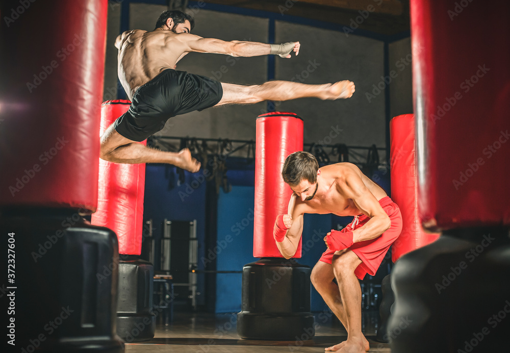 Kickboxer kick in the air against the opponent.