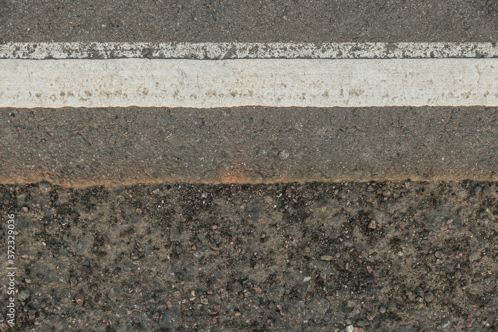 Fototapeta premium road markings on asphalt close up