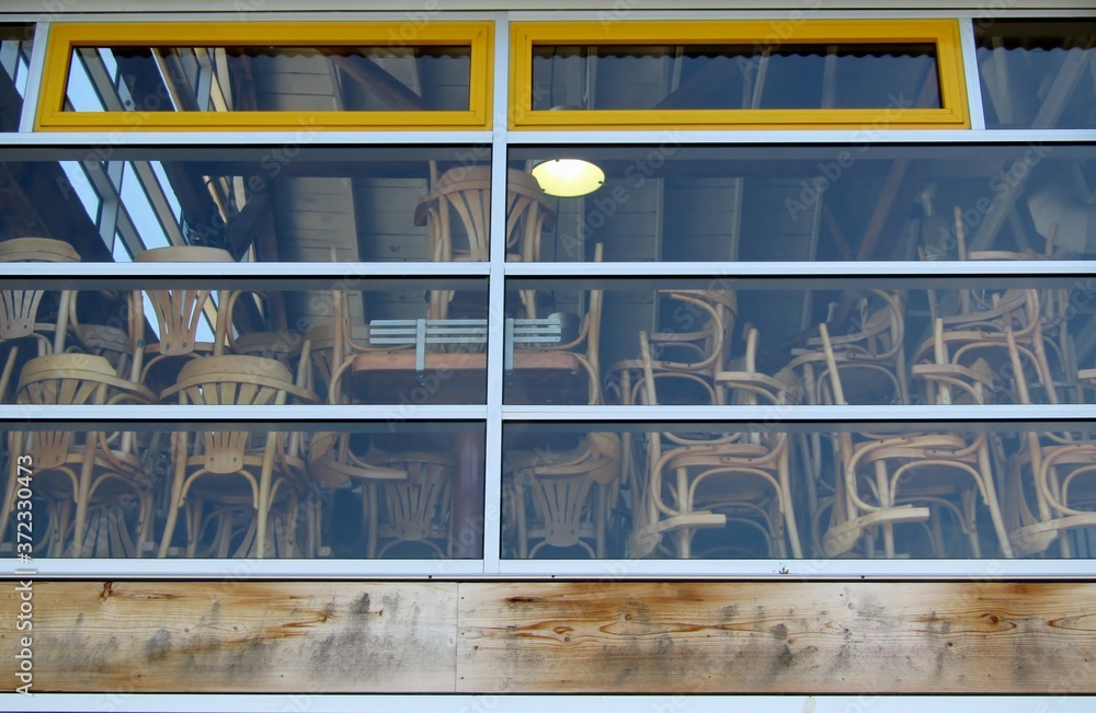 Stacked furniture in closed cafe. Granville Island, Vancouver, BC, Canada Stacked furniture in closed cafe. Granville Island, Vancouver, BC, Canada