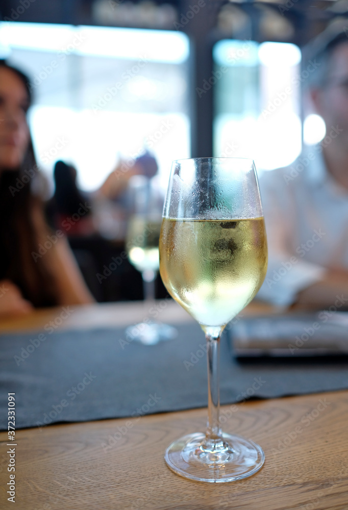 Wine tasting event - glass of white wine at a wine lounge