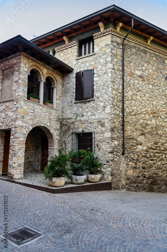 Fototapeta Naklejka Na Ścianę i Meble -  The narrow ancient streets and architecture of the city of Sirmione. Lake Garda, Northern Italy