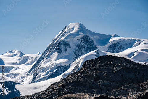 The summit of Liskamm (Lyskamm), famous alpine peak above Zermatt, Switzerland. Moutain alpine landscape of Wallis. Snow and ice covered peak, Monte Rosa Glacier. photo