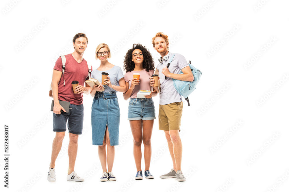 Multiethnic students with coffee to go and books looking at camera on white background Multiethnic students with coffee to go and books looking at camera on white background