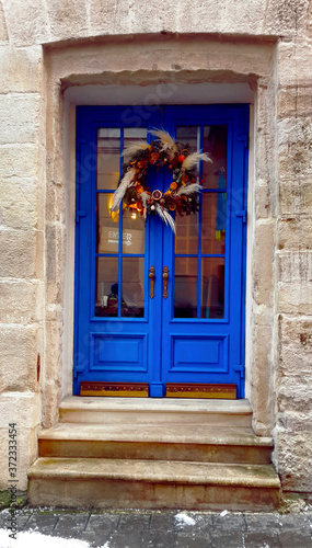 blue door with the christmas wreath © anna
