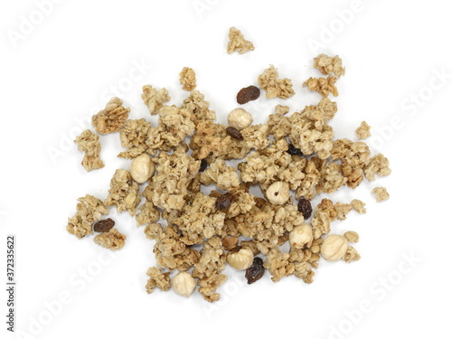 Pile of granola from above isolated on a white background. CRUNCHY hazelnut muesli isolated.
