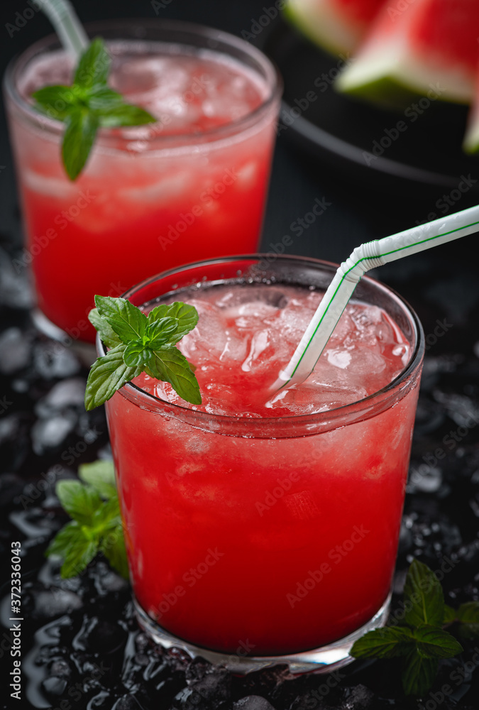 Summer cold drink with watermelon and mint on a black wooden background. Summer cold drink with watermelon and mint on a black wooden background.