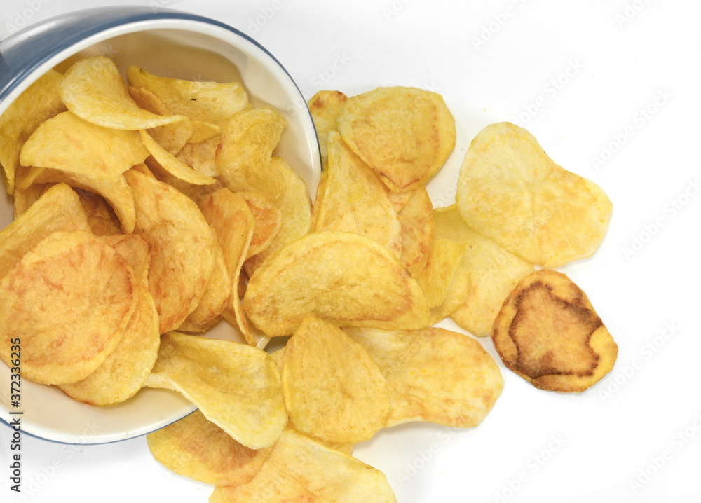 Salty Potato chips isolated on white background.